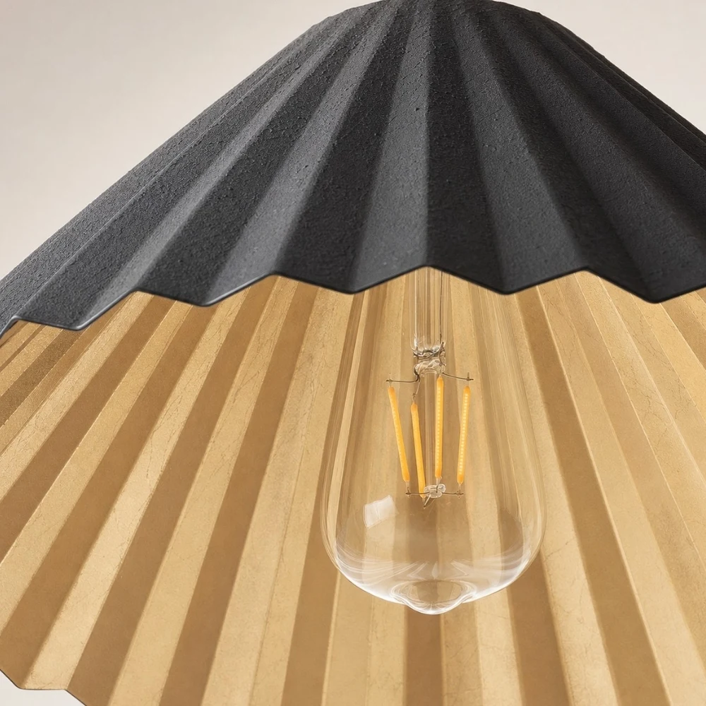 Black pleated metal shade and bulb detail
