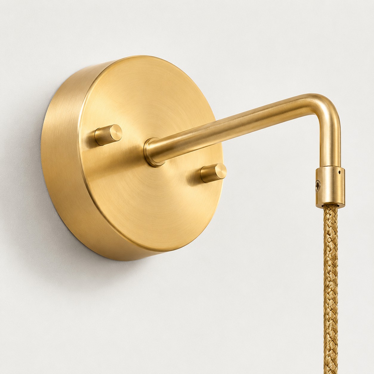 Round brass wall plate and arm connection detail