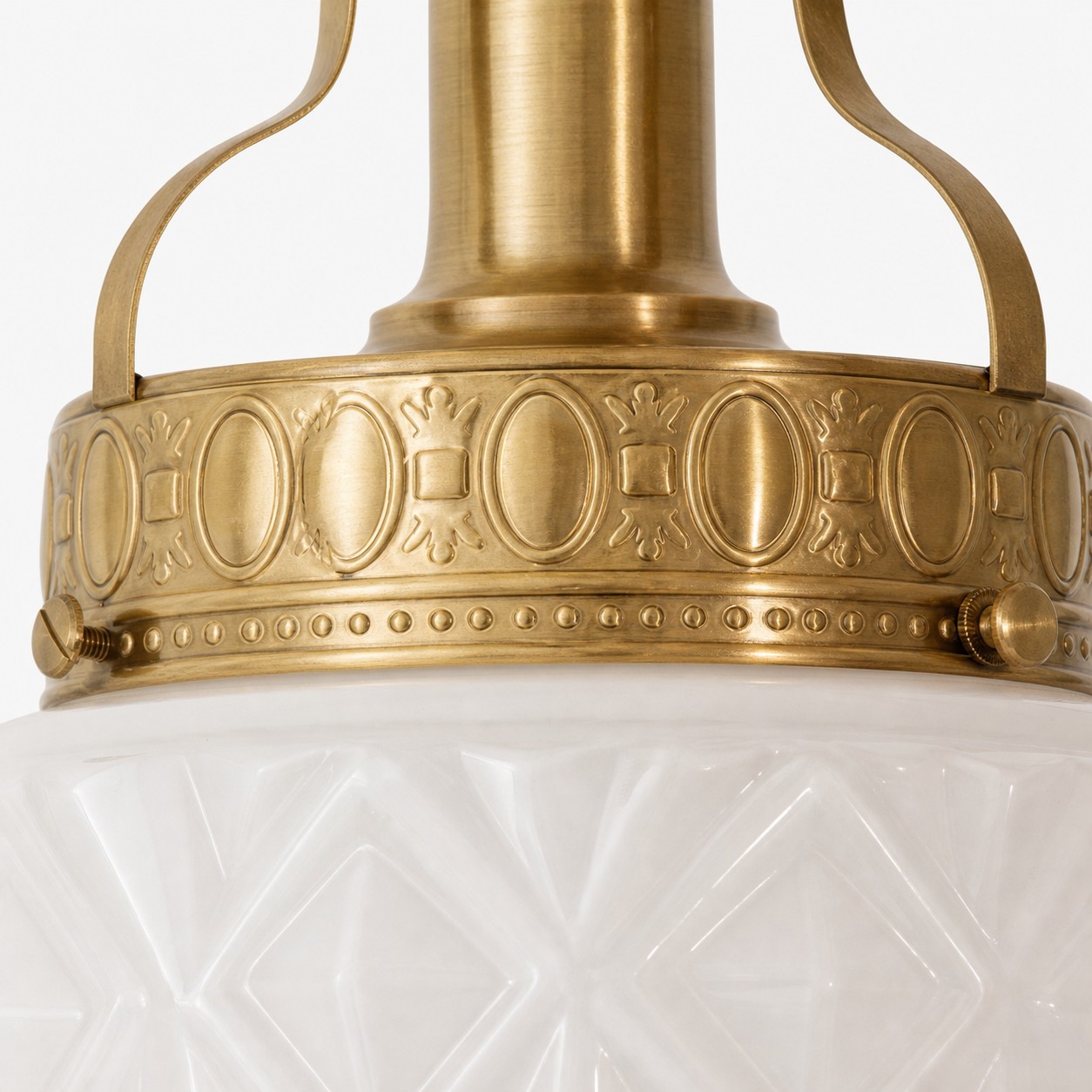 Embossed brass frame detail on the ceiling light