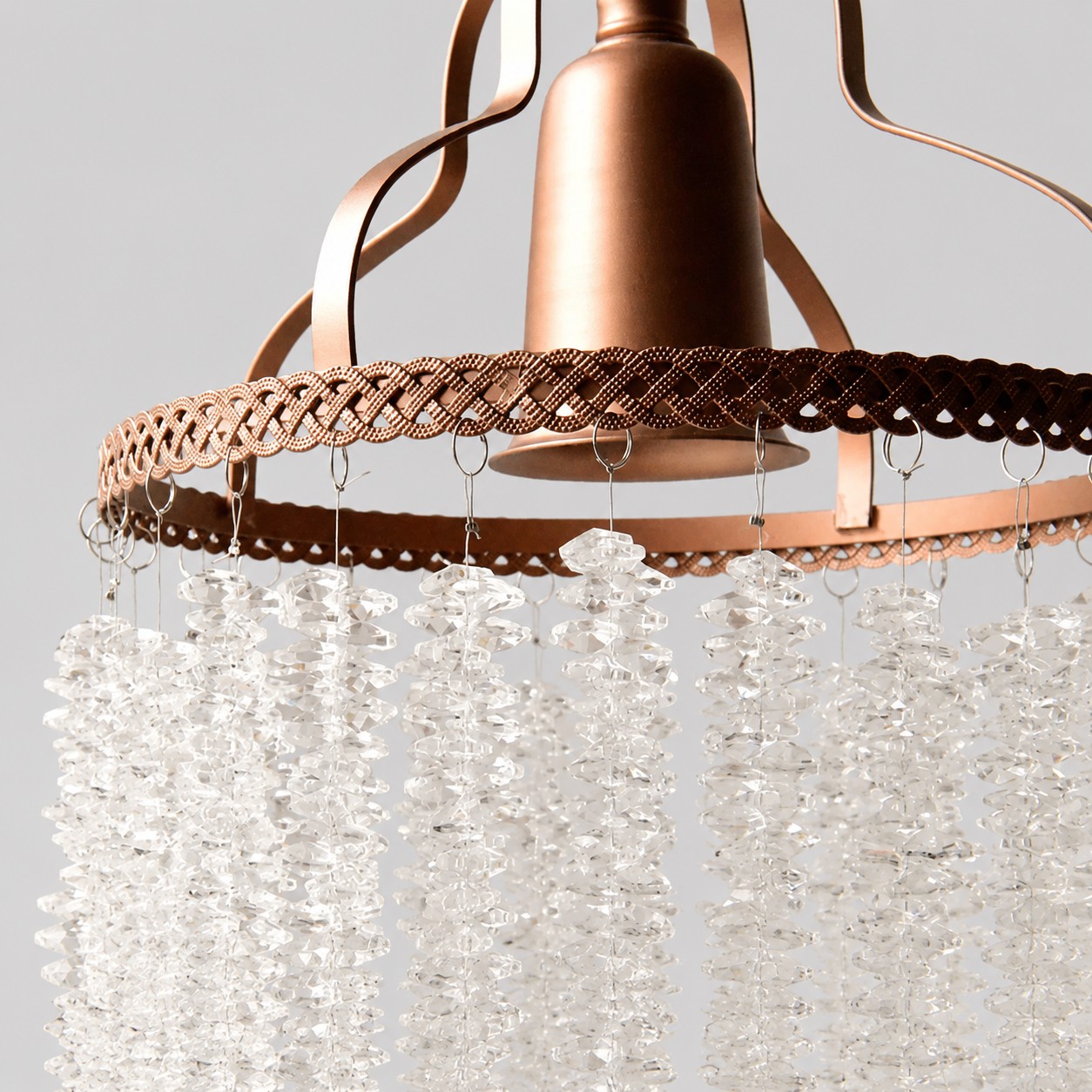 Close view of the woven metal rim and crystal strand attachments