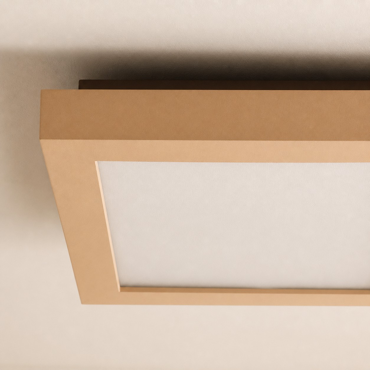 Close detail of cream square metal ceiling lamp frame and diffuser panel