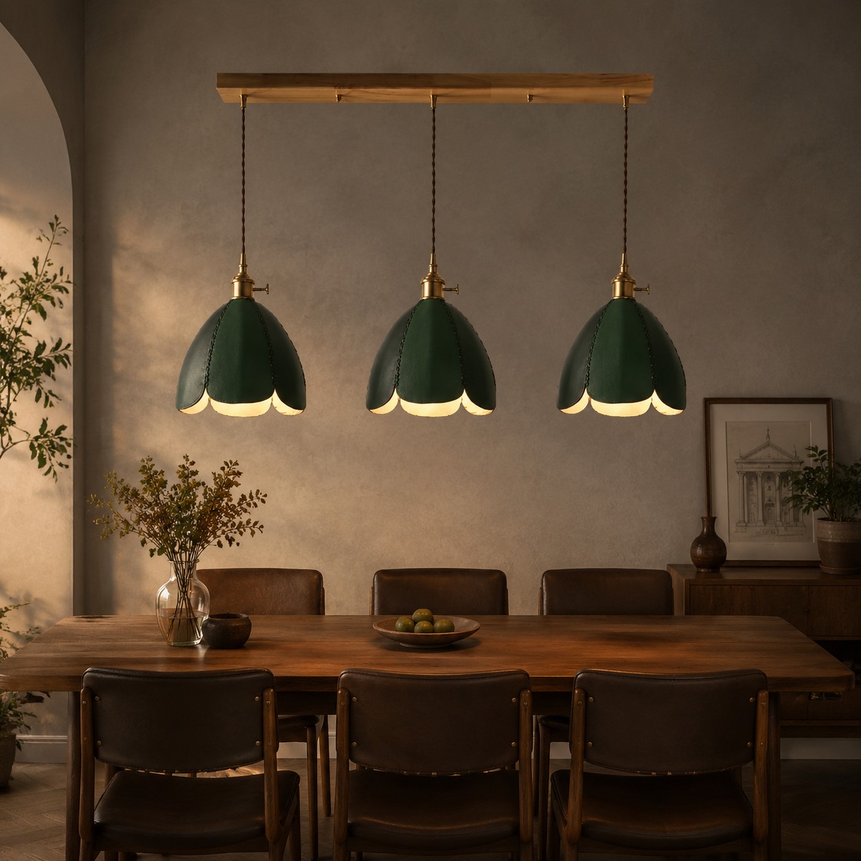 Three green leather pendant lights above a dining table