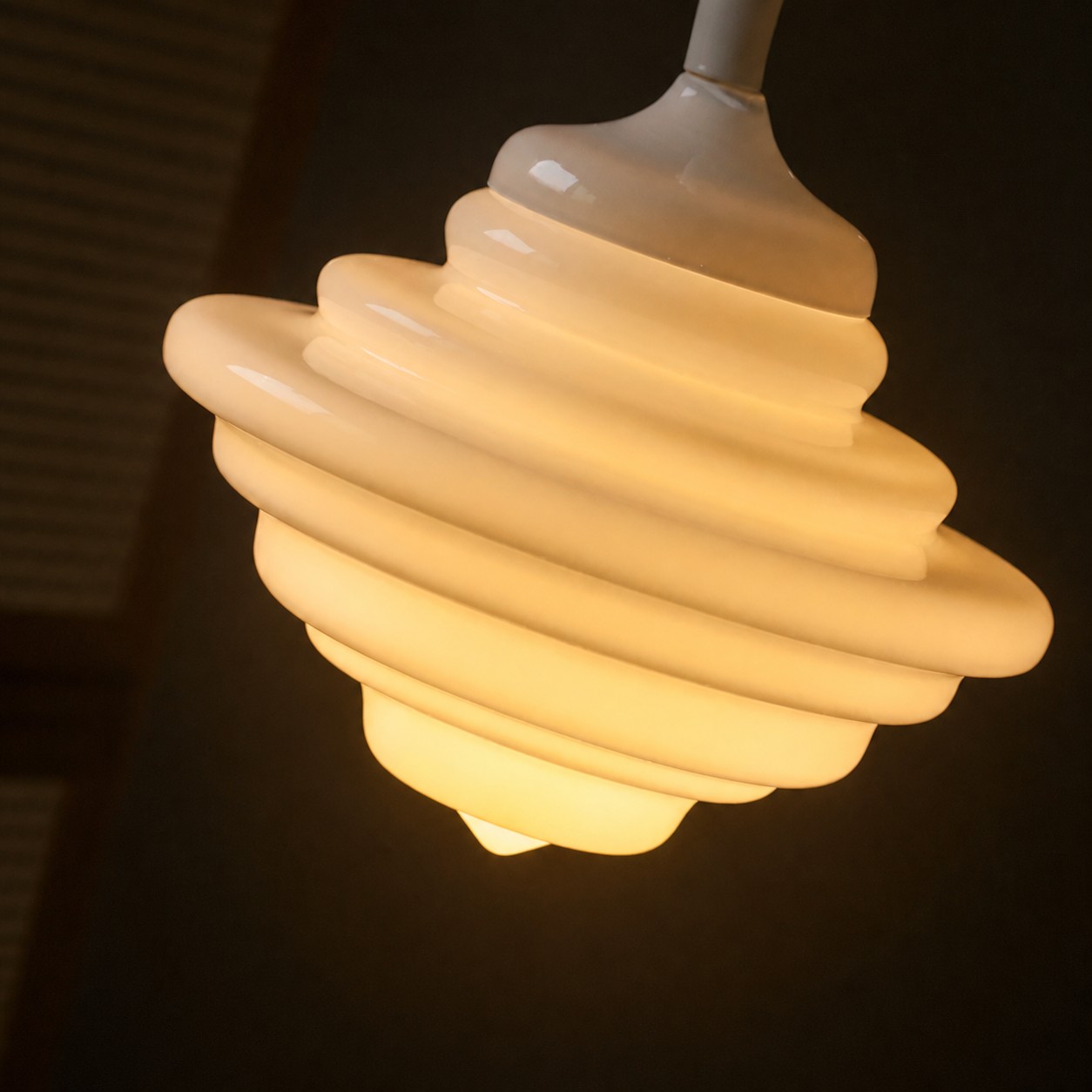 Illuminated white glass pendant close view