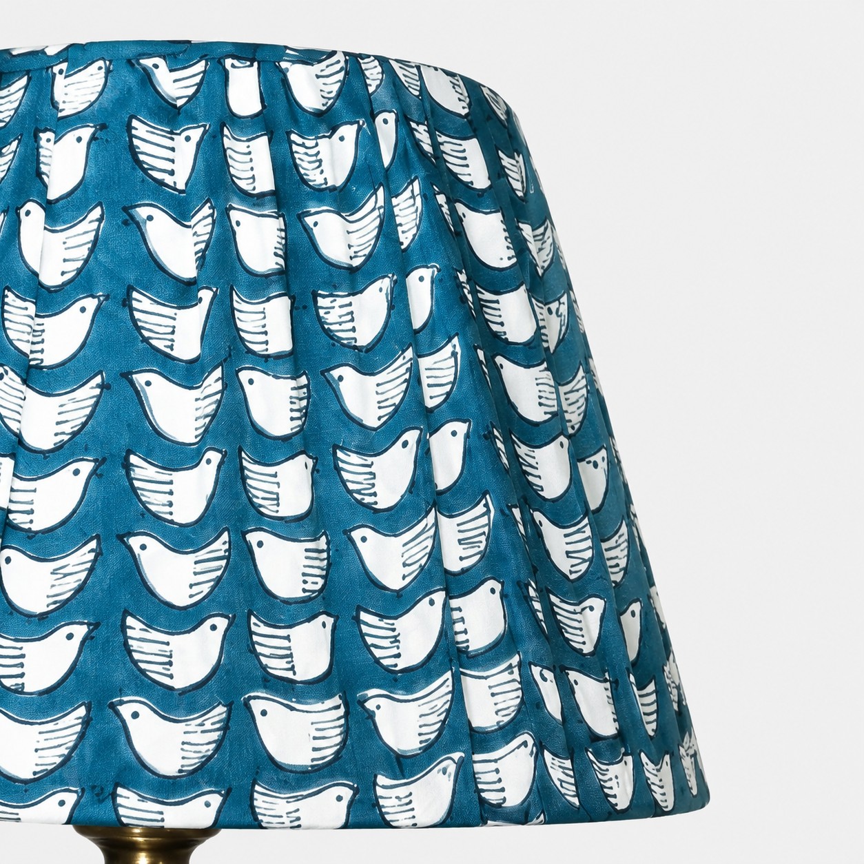 Teal pleated fabric shade with white bird pattern detail