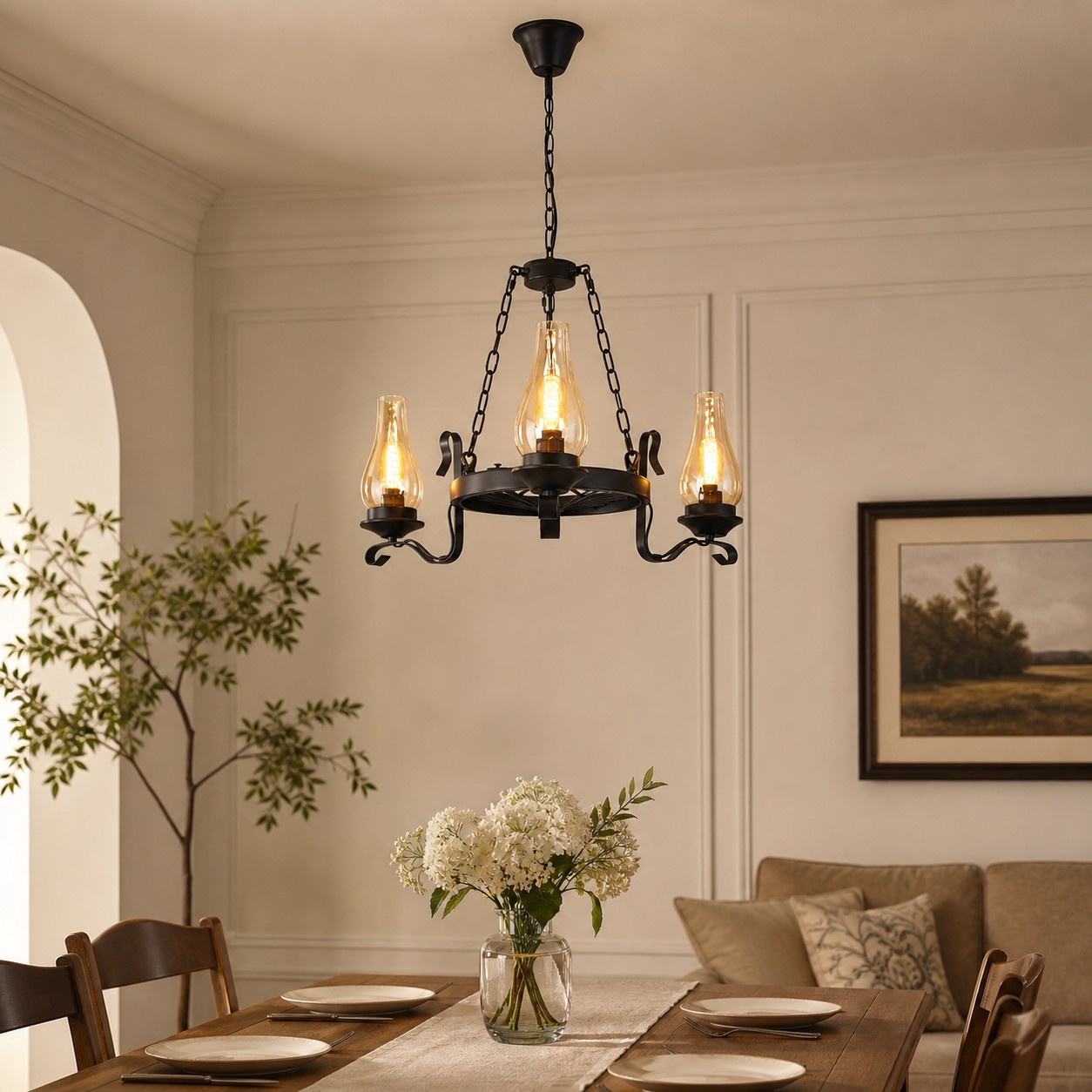Three-light hurricane glass chandelier above a warm dining table