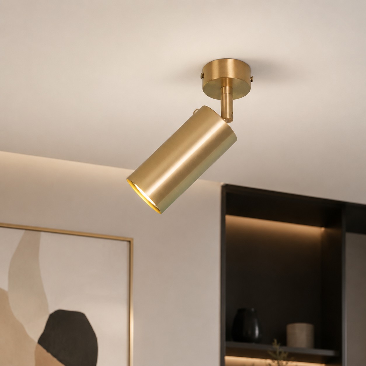 Brass adjustable ceiling spotlight close installed scene