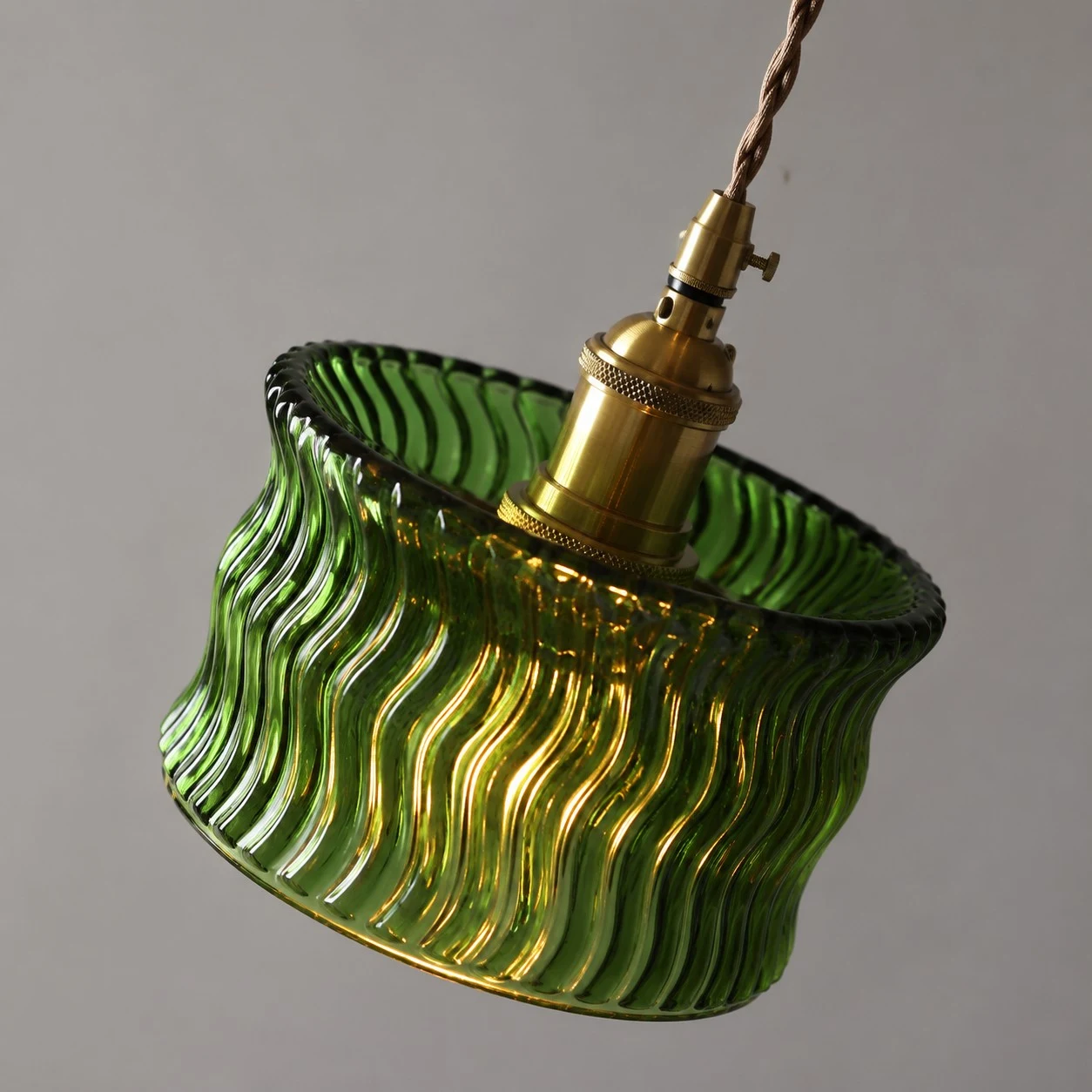 Angled view of the green ripple glass shade and adjustable cord